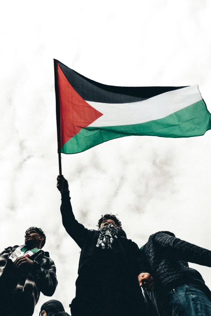 free photo of men manifesting with flag of palestine